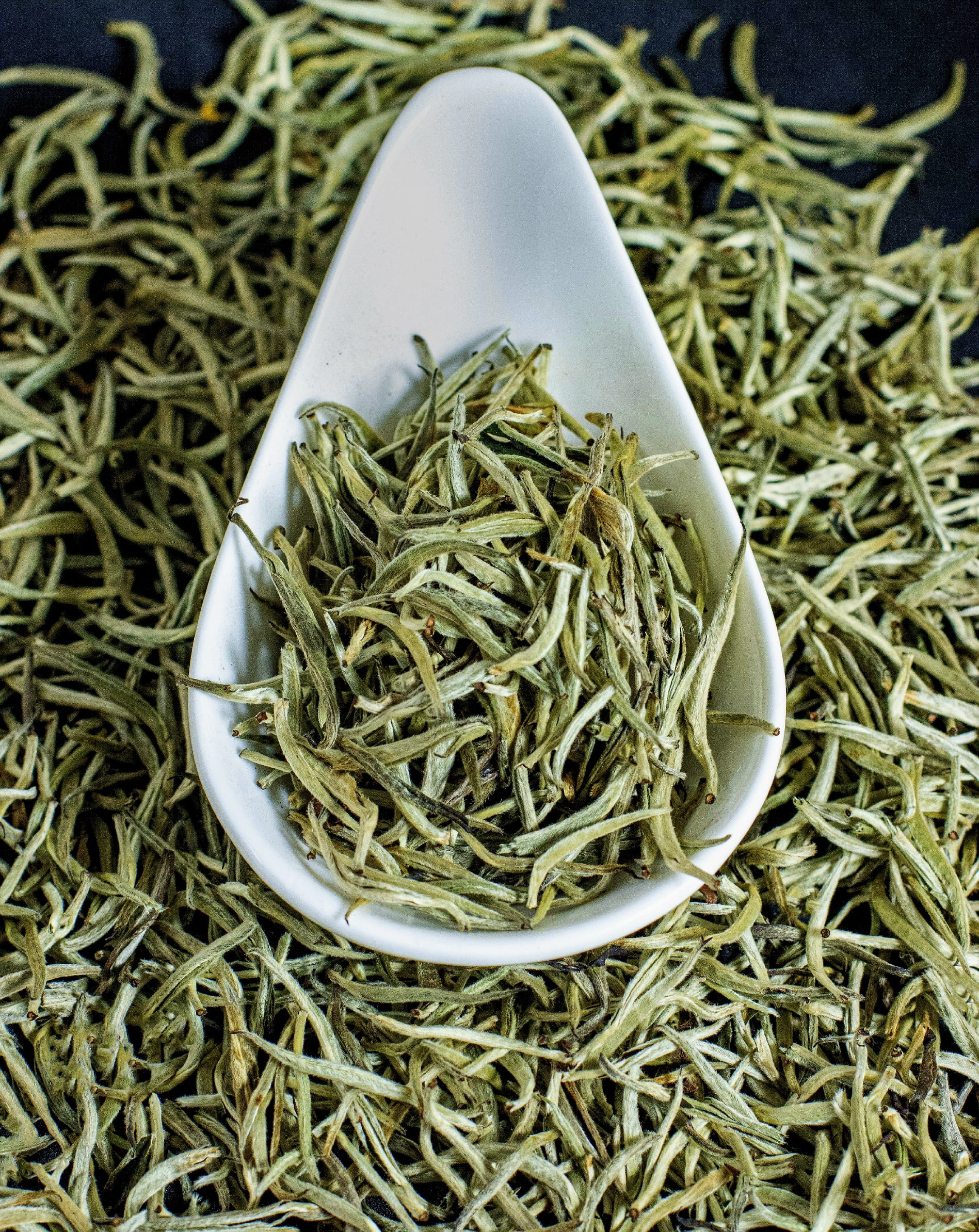 Delicate tea leaves and light infusion representing Kenyan white tea